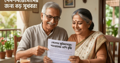 Two Smiling Elderly Indian Couple Sit at a Table Reading a Pension Information Document Together at Home with a Glass of Tea on the Table